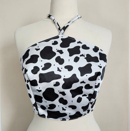 Black and white cow print bikini top on a mannequin
