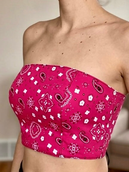 Pink bandana patterned strapless top worn by a person.