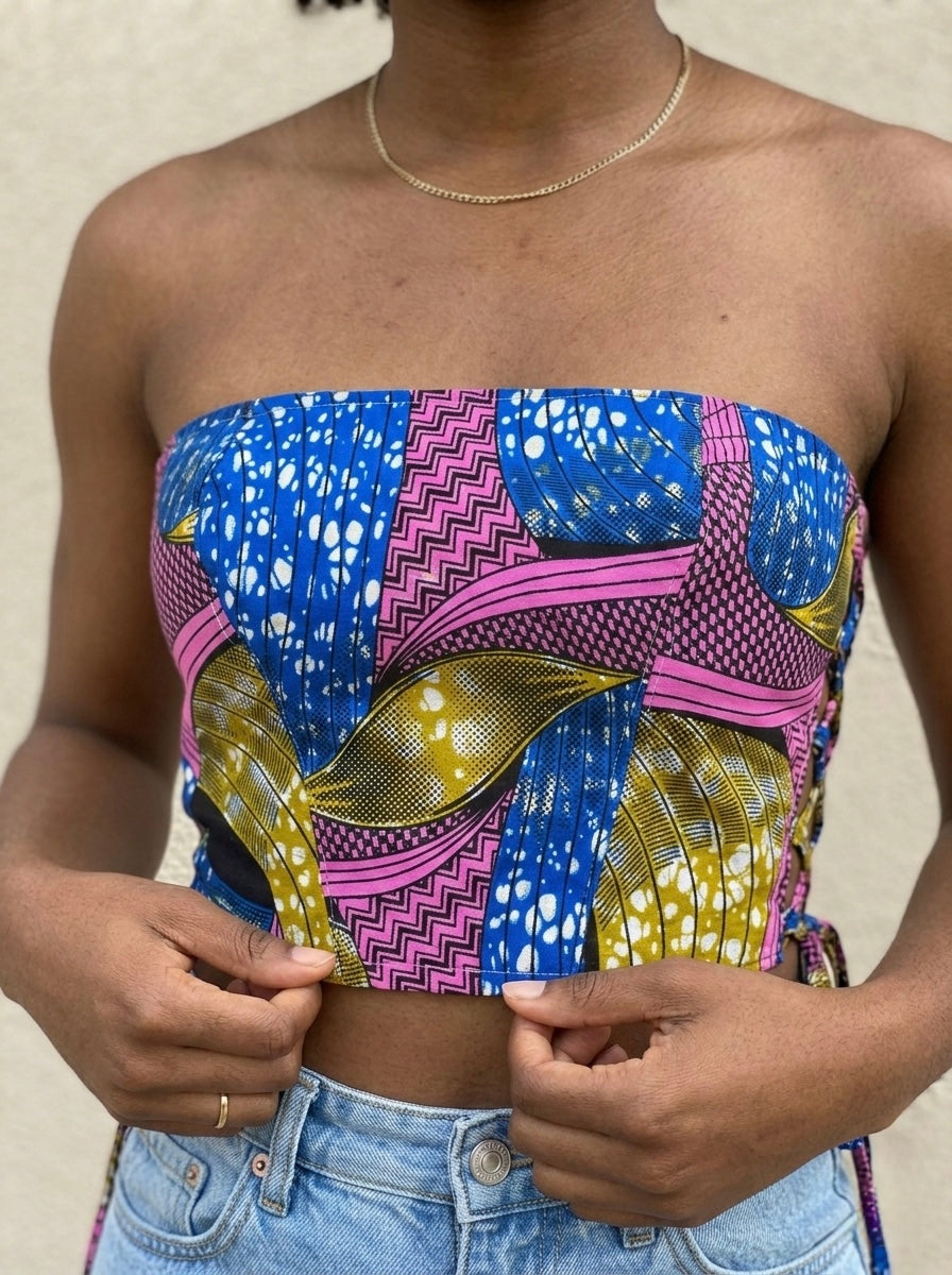 Colorful strapless top with geometric African pattern worn by a person, against a neutral background